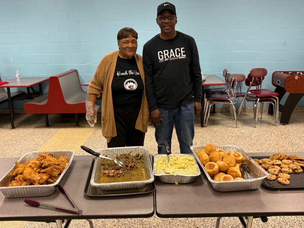 High school football team meal served by church volunteers